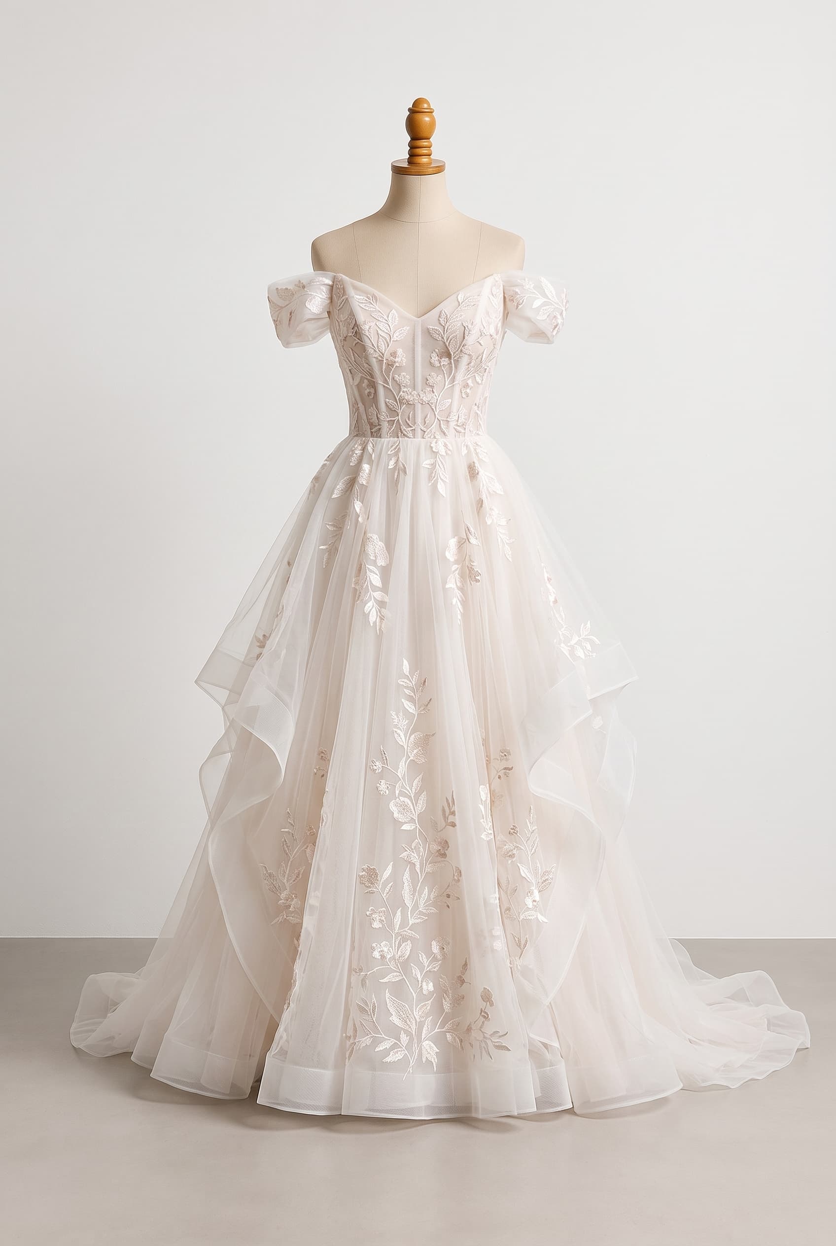 A light, dreamy bridal dress inspired by a summer garden, with airy layers, softly gathered volume, and botanical embroidery that moves beautifully down the aisle; A subtly structured corset bodice veiled in embroidered organza, giving graceful definition without losing its ethereal softness; clean front line, elegant movement, and refined restraint