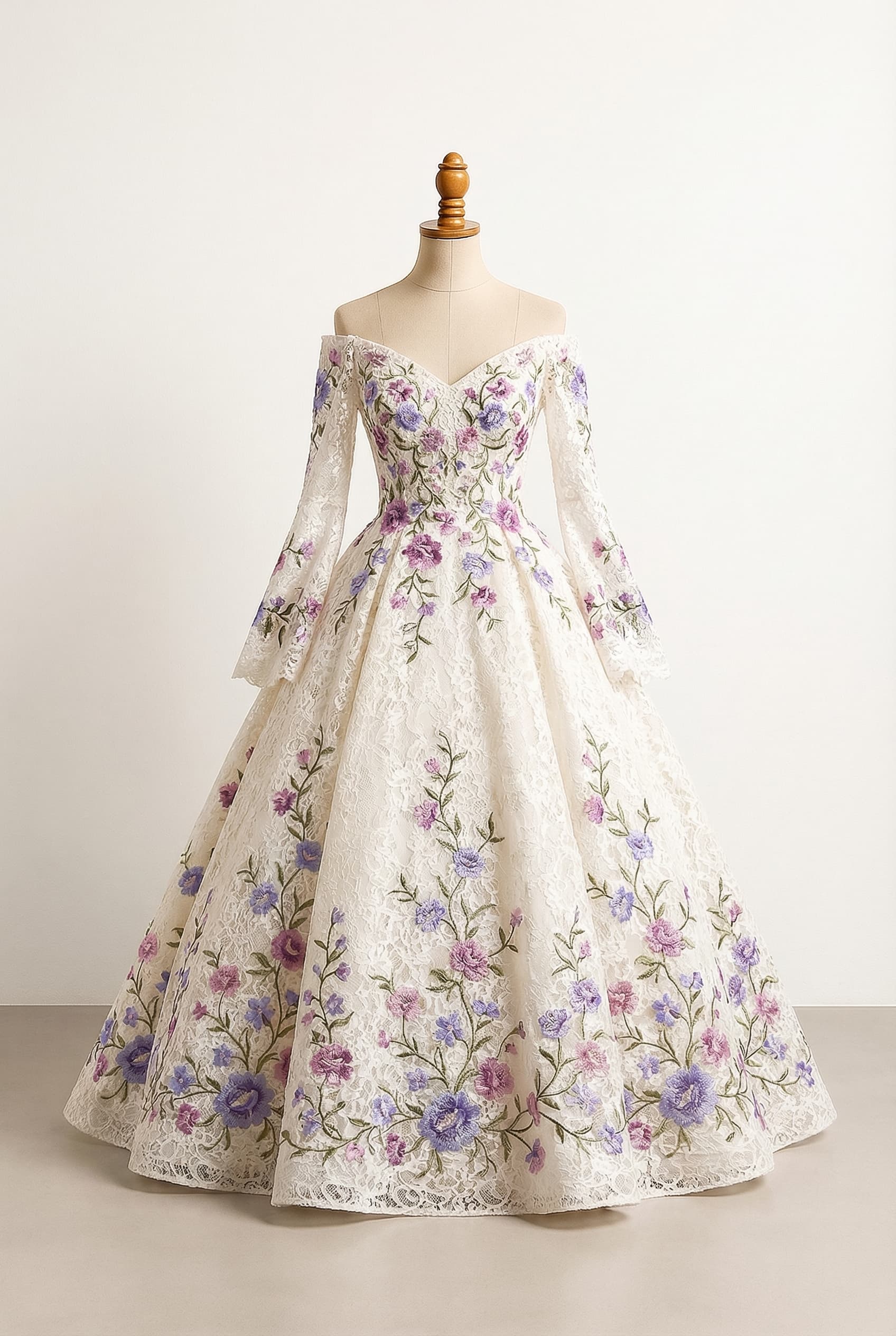 Balanced custom dress off white off-the-shoulder neckline with a V shape princess cut dress with floral embellishments in purple pink and periwinkle with green vinesleaves as an accent small floral pattern sleeves starting at the middle of the upper arm and flowing down to the wrists widening as it goes down lacy material. Floral embellishments from the floor up to the bust.